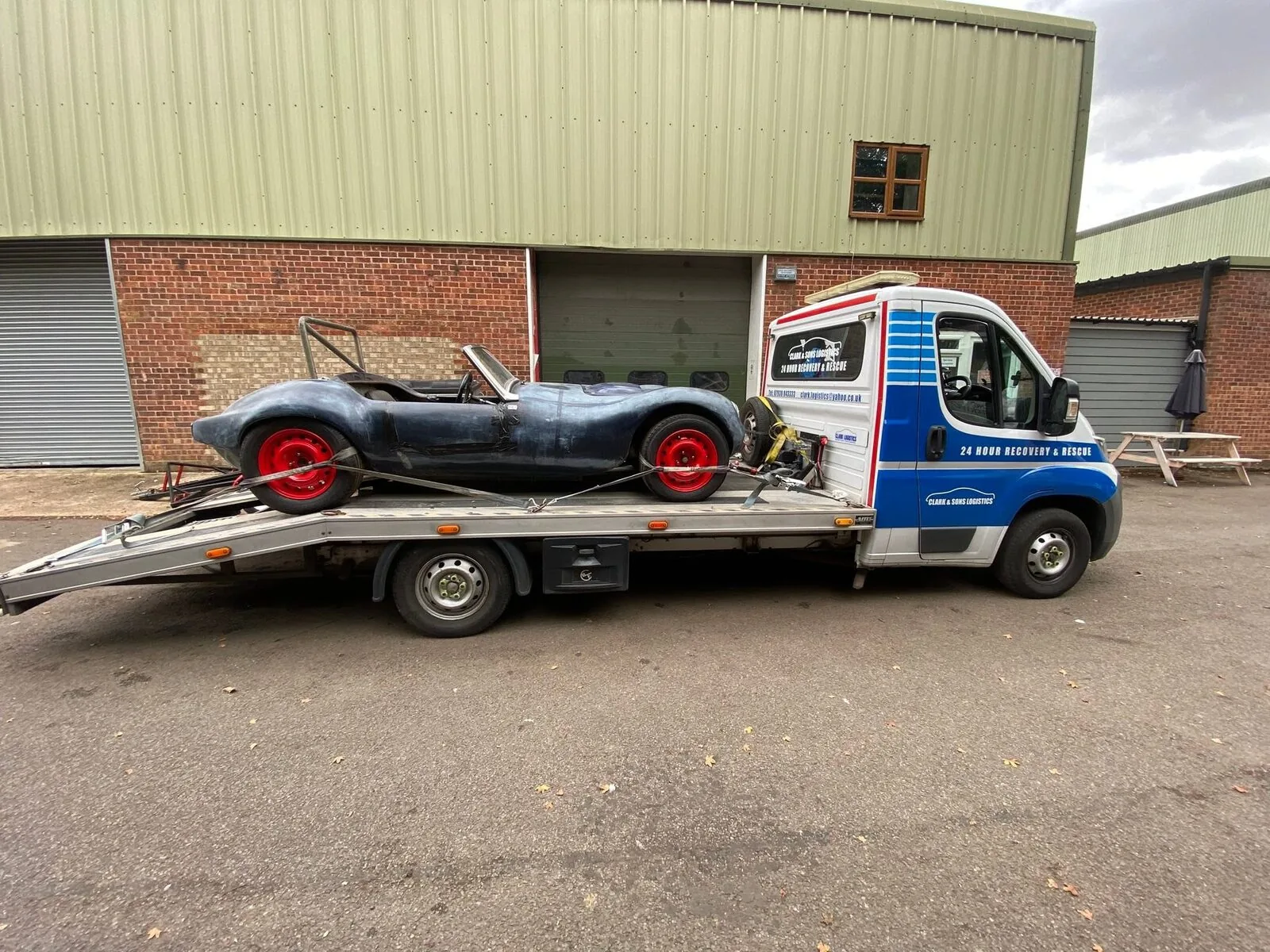 Open-top specialist replica build secured on a Clark & Sons Logistics flatbed